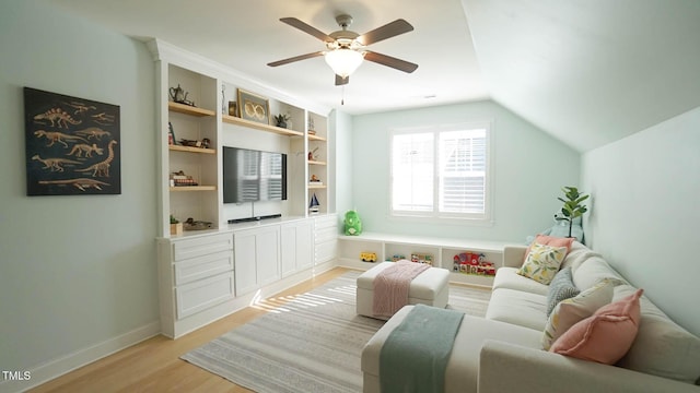 living room with lofted ceiling, light wood-style flooring, baseboards, and ceiling fan