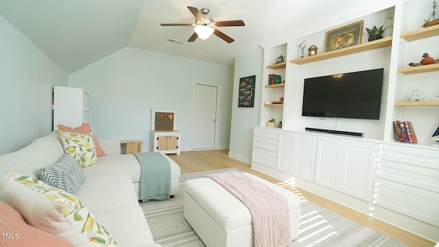 living area with light wood-style flooring, built in shelves, a ceiling fan, and visible vents