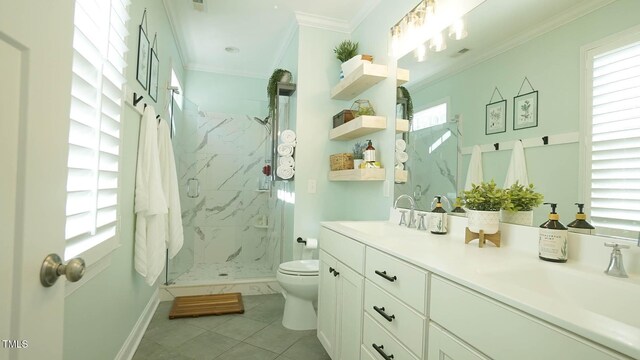 bathroom featuring a marble finish shower, toilet, crown molding, and a sink