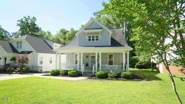 view of front of property with a porch, board and batten siding, and a front yard