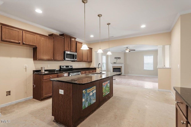 kitchen with ceiling fan, baseboards, appliances with stainless steel finishes, and a sink