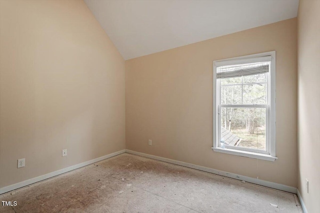 spare room featuring lofted ceiling