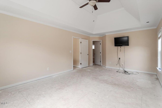 interior space featuring baseboards, crown molding, and a tray ceiling