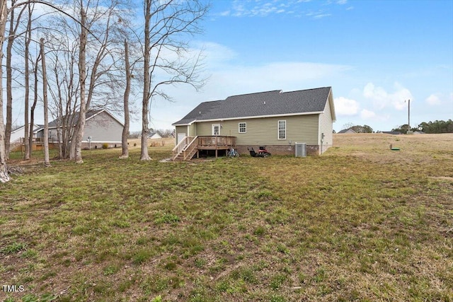 back of property featuring cooling unit, a lawn, and a wooden deck