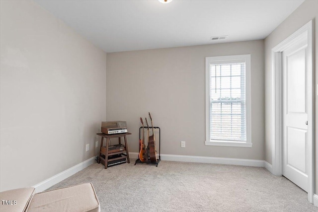 interior space featuring baseboards, visible vents, and carpet floors