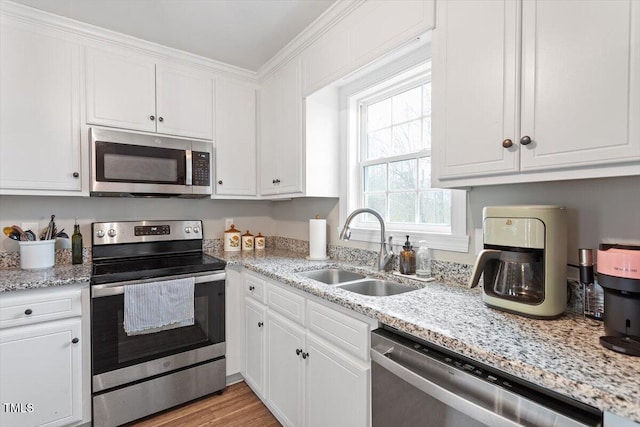 kitchen featuring a sink, white cabinets, and stainless steel appliances