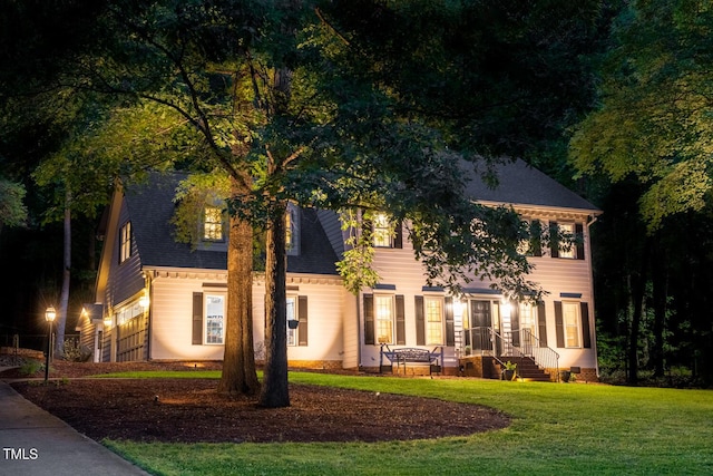 colonial house with roof with shingles and a front yard