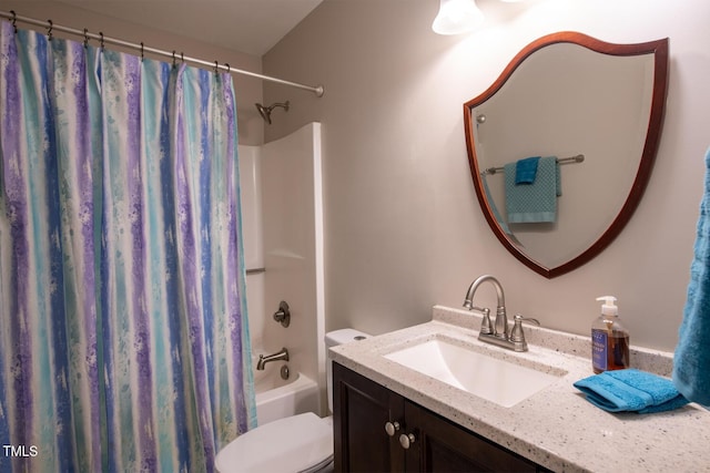 bathroom with shower / bath combo with shower curtain, toilet, and vanity