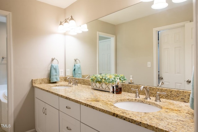 full bathroom featuring double vanity and a sink