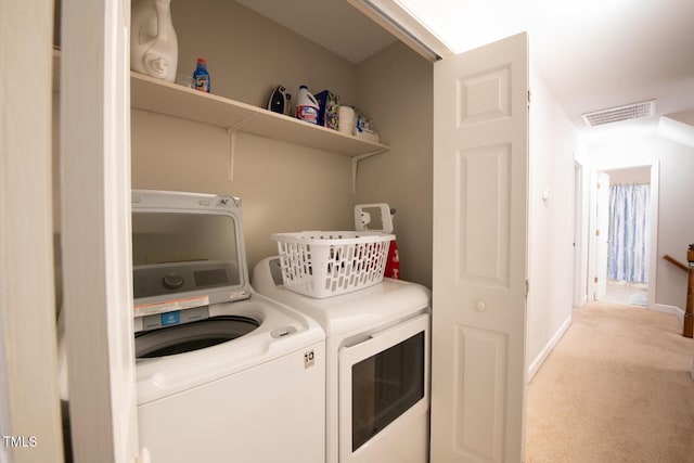 laundry room with visible vents, washer and dryer, carpet, baseboards, and laundry area