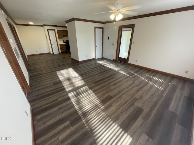 unfurnished living room with baseboards, dark wood-type flooring, and crown molding