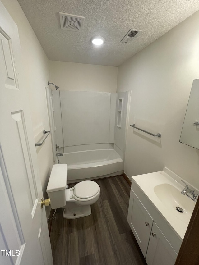 bathroom with visible vents, toilet, shower / tub combination, and wood finished floors