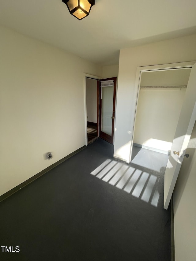 unfurnished bedroom featuring a closet and baseboards