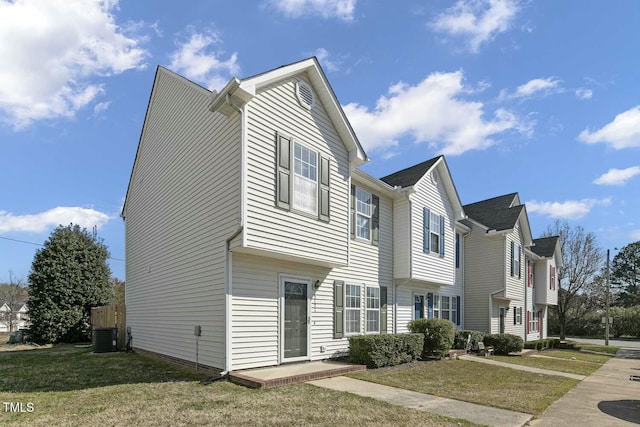 view of home's exterior with central AC and a yard