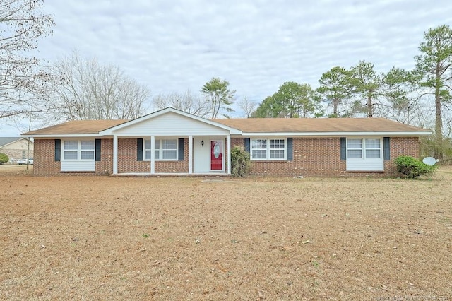 single story home featuring brick siding