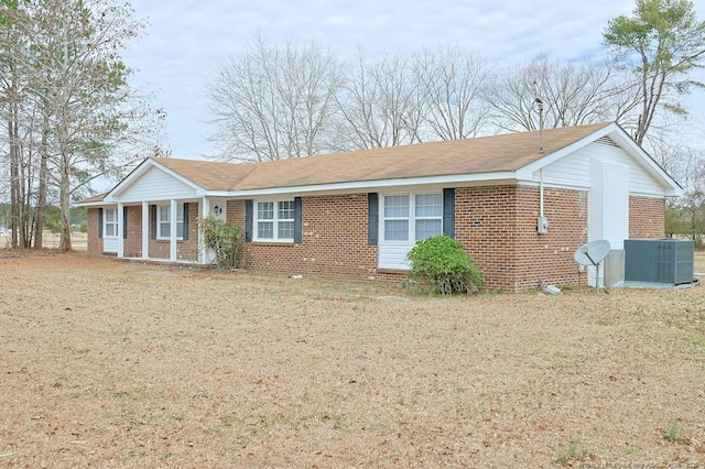 ranch-style house with brick siding and central AC