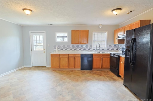 kitchen with black appliances, light countertops, visible vents, and a sink