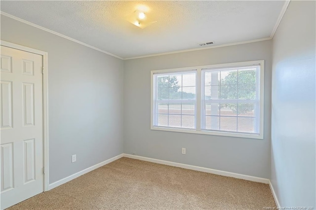 empty room featuring light carpet, visible vents, a textured ceiling, and baseboards