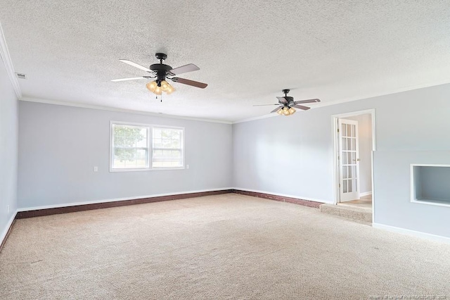 carpeted empty room with visible vents, ornamental molding, a ceiling fan, a textured ceiling, and baseboards