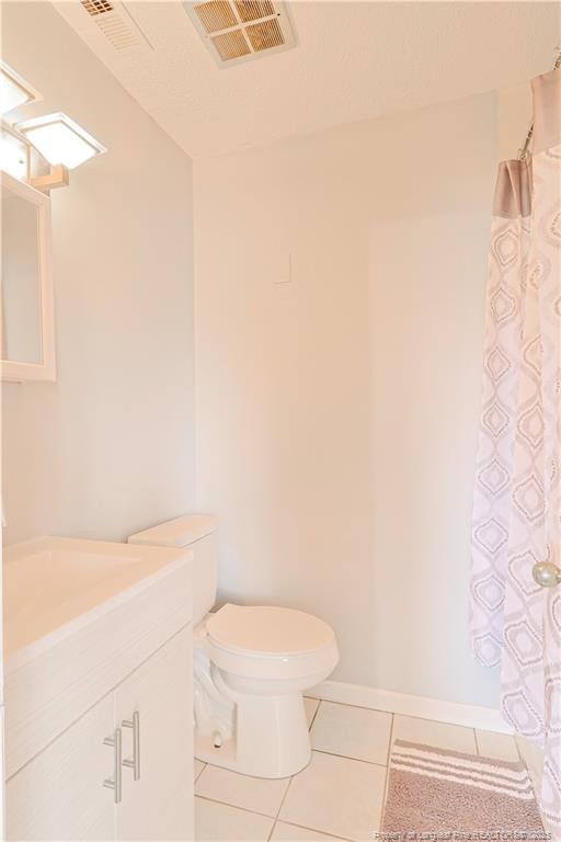 full bath featuring visible vents, toilet, a shower with curtain, tile patterned floors, and vanity