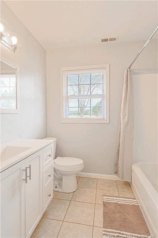 full bath featuring a wealth of natural light, visible vents, vanity, and tile patterned floors