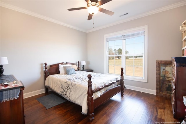 bedroom with crown molding, wood finished floors, visible vents, and baseboards