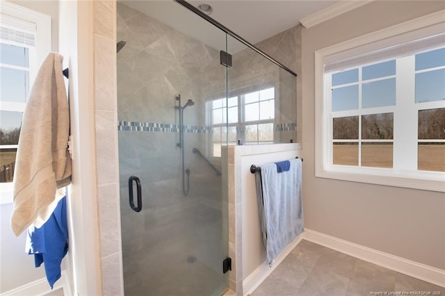 full bathroom with a stall shower, baseboards, and ornamental molding