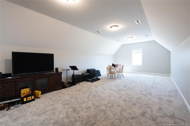 interior space with visible vents, carpet floors, baseboards, and vaulted ceiling