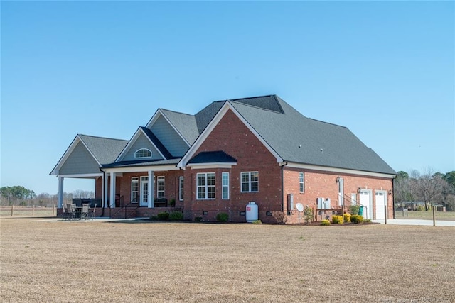 view of front facade with crawl space, brick siding, and a front lawn