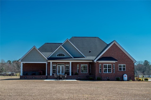 craftsman house featuring crawl space, french doors, and brick siding