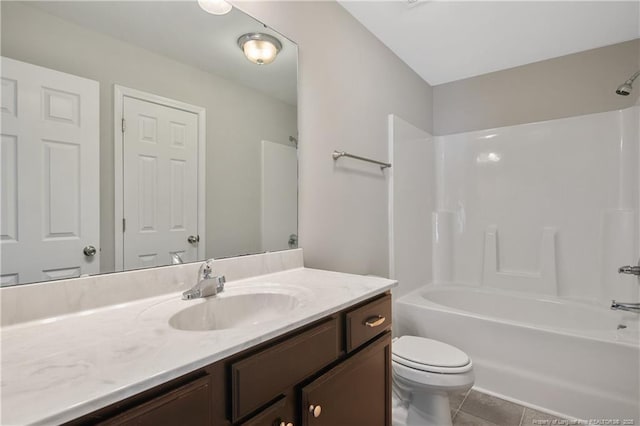 bathroom featuring vanity, toilet, bathtub / shower combination, and tile patterned flooring