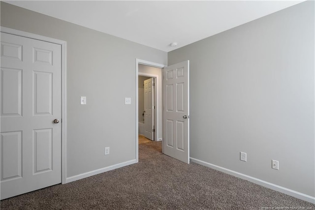 unfurnished bedroom featuring baseboards and carpet