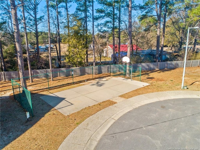 view of basketball court with community basketball court and fence