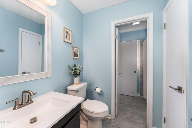 bathroom with tile patterned floors, toilet, and vanity