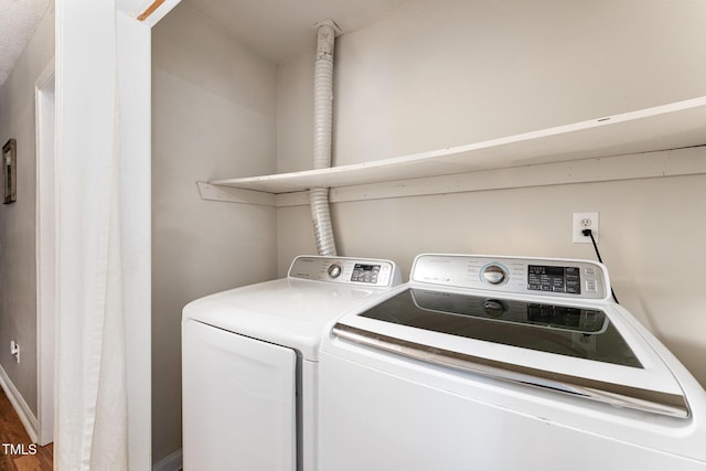 laundry room with laundry area and washing machine and clothes dryer