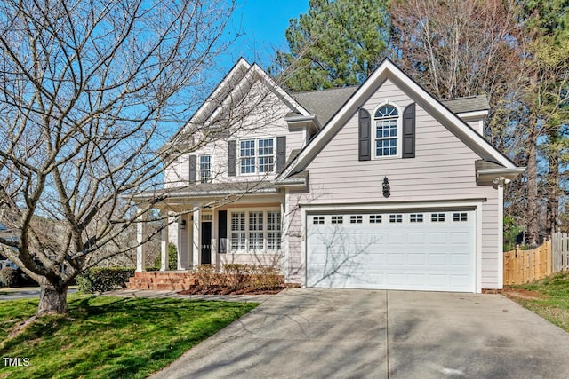 traditional-style home featuring a front lawn, fence, concrete driveway, roof with shingles, and a garage