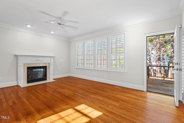 unfurnished living room featuring visible vents, wood finished floors, ceiling fan, and ornamental molding