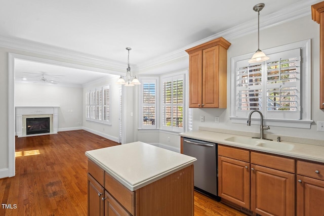 kitchen featuring a sink, stainless steel dishwasher, crown molding, light countertops, and dark wood-style flooring