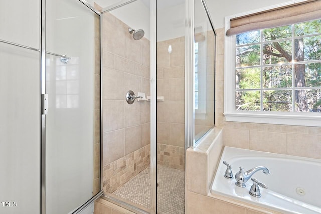 full bathroom featuring a stall shower and a jetted tub