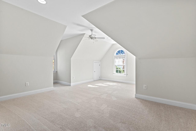 additional living space with lofted ceiling, a ceiling fan, carpet, and baseboards