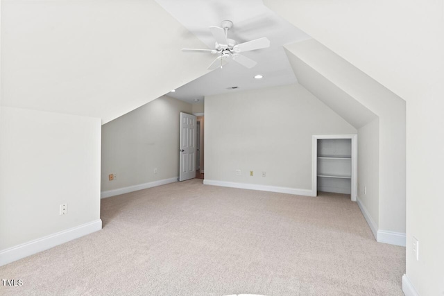 bonus room with light carpet, baseboards, a ceiling fan, and vaulted ceiling