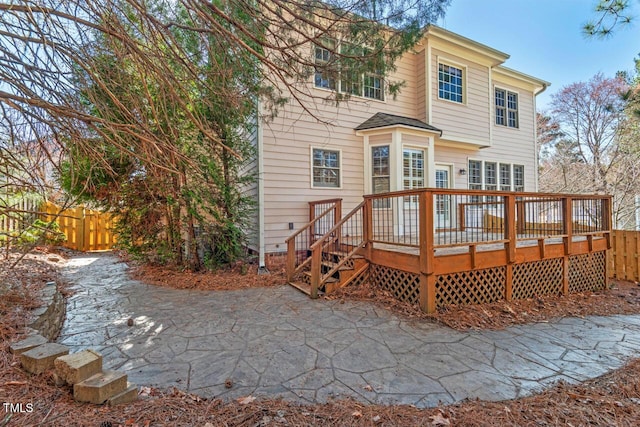 back of property with a patio, fence, and a wooden deck