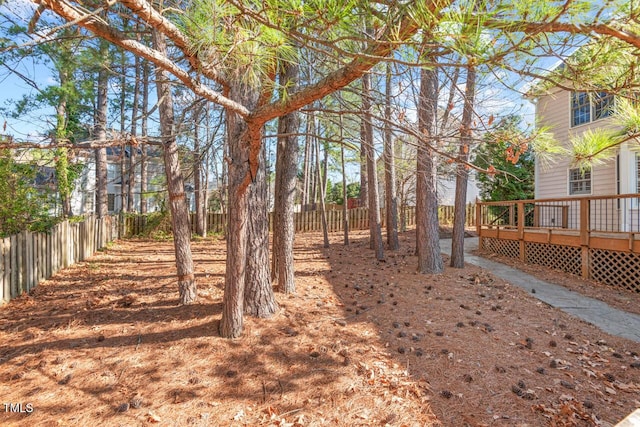 view of yard with a deck and a fenced backyard