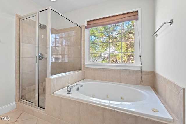 bathroom featuring a shower stall, a tub with jets, and tile patterned floors