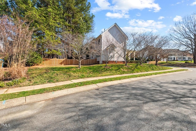 view of home's exterior with fence