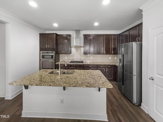 kitchen with a sink, ornamental molding, stainless steel appliances, wall chimney range hood, and backsplash