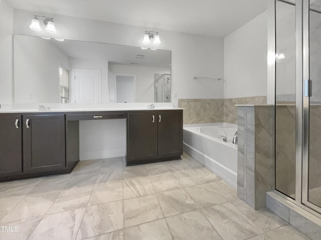 bathroom with double vanity, a bath, a stall shower, and a sink