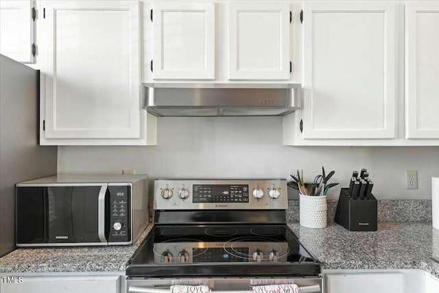 kitchen featuring white cabinetry, stainless steel electric range oven, and wall chimney range hood