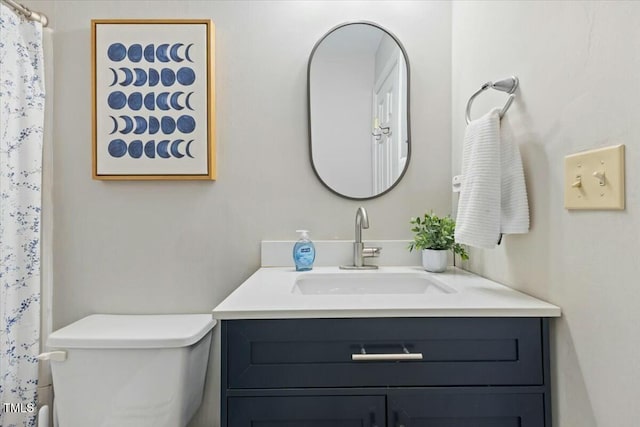 bathroom with vanity, a shower with shower curtain, and toilet