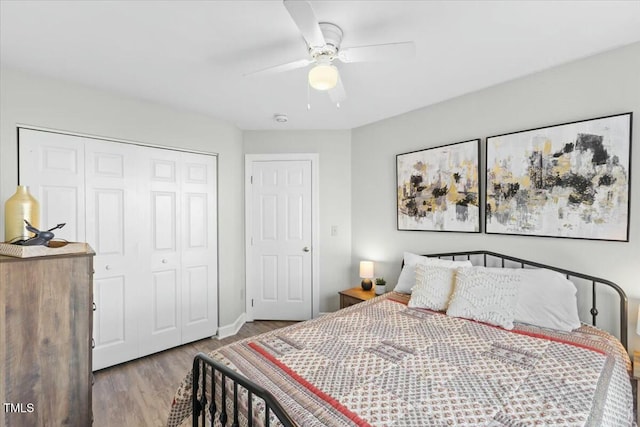 bedroom featuring a closet, wood finished floors, and a ceiling fan